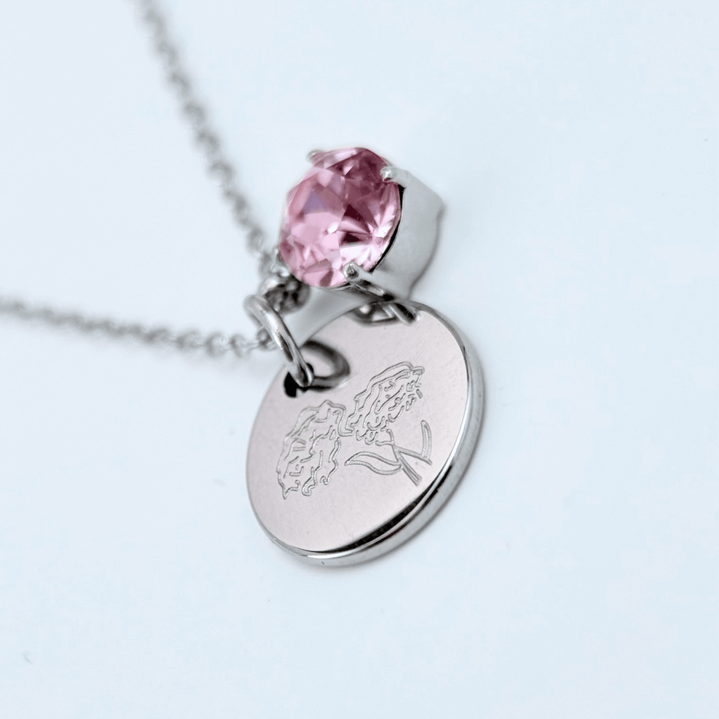 silver birth month necklace with blue crystal and engraved flower pendant