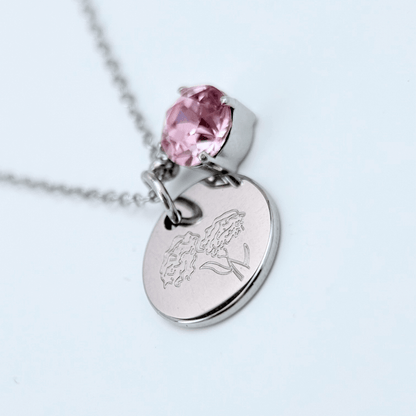silver birth month necklace with blue crystal and engraved flower pendant