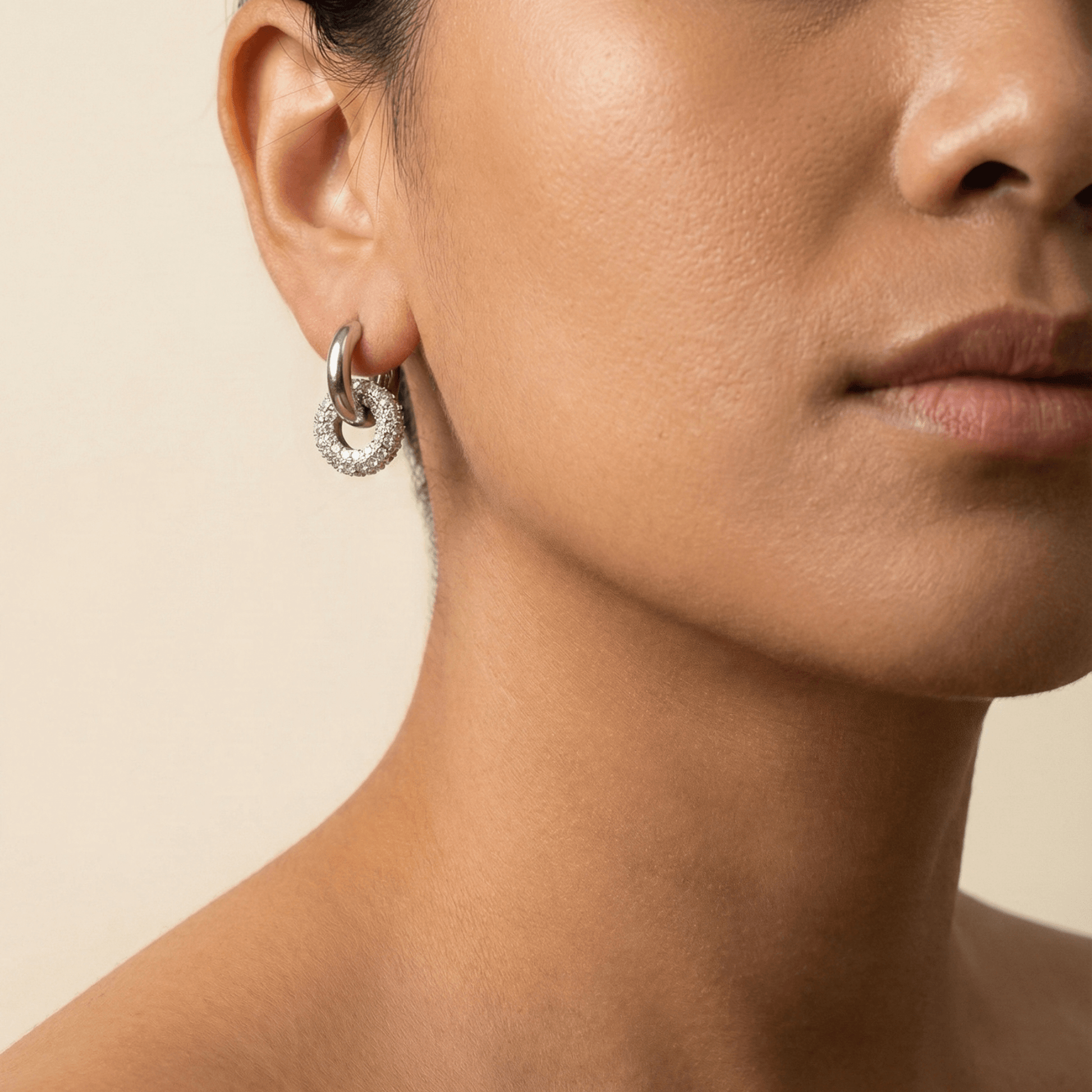 Modern silver hoop earrings with round crystal halo charm