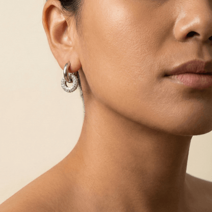 Modern silver hoop earrings with round crystal halo charm