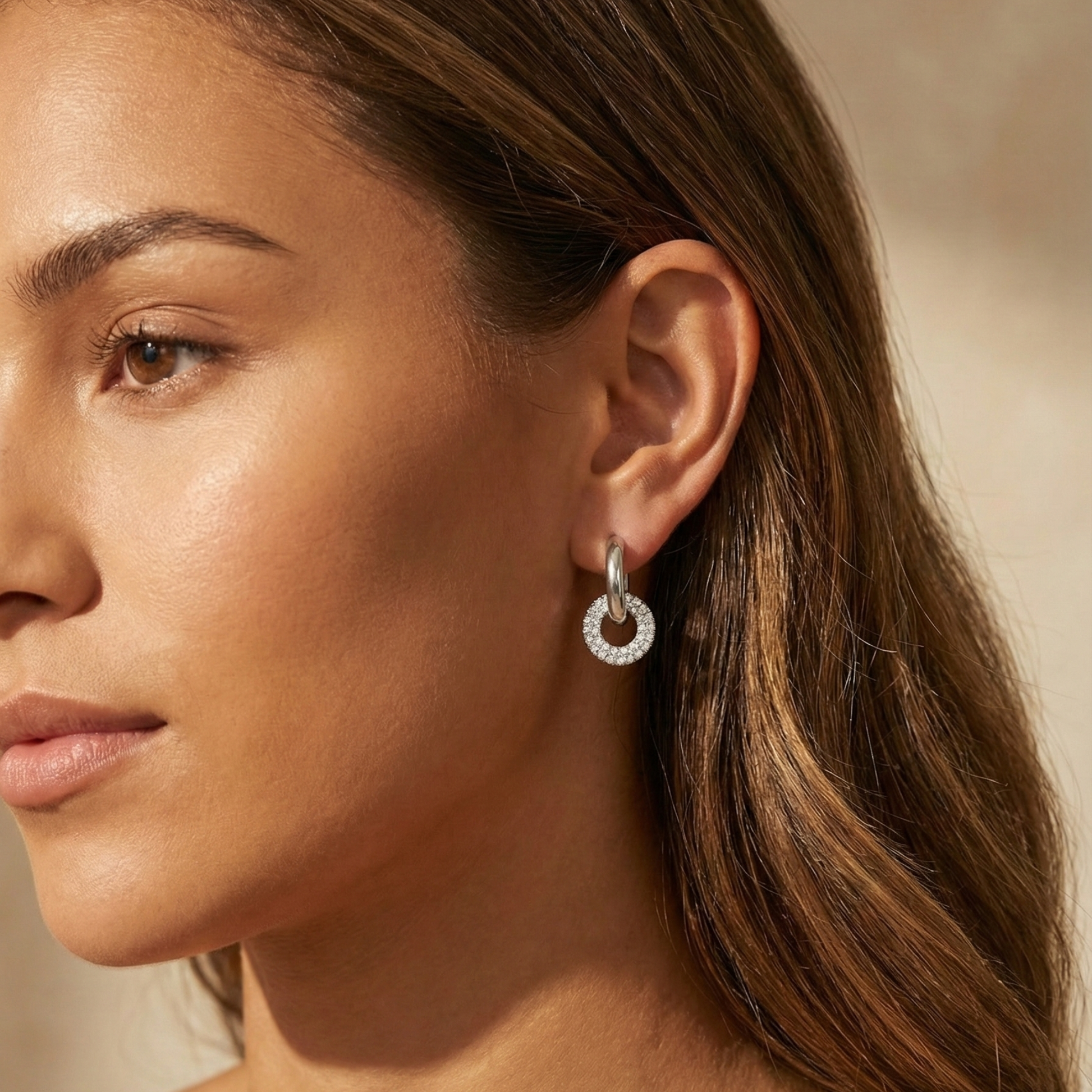 Modern silver hoop earrings with round crystal halo charm