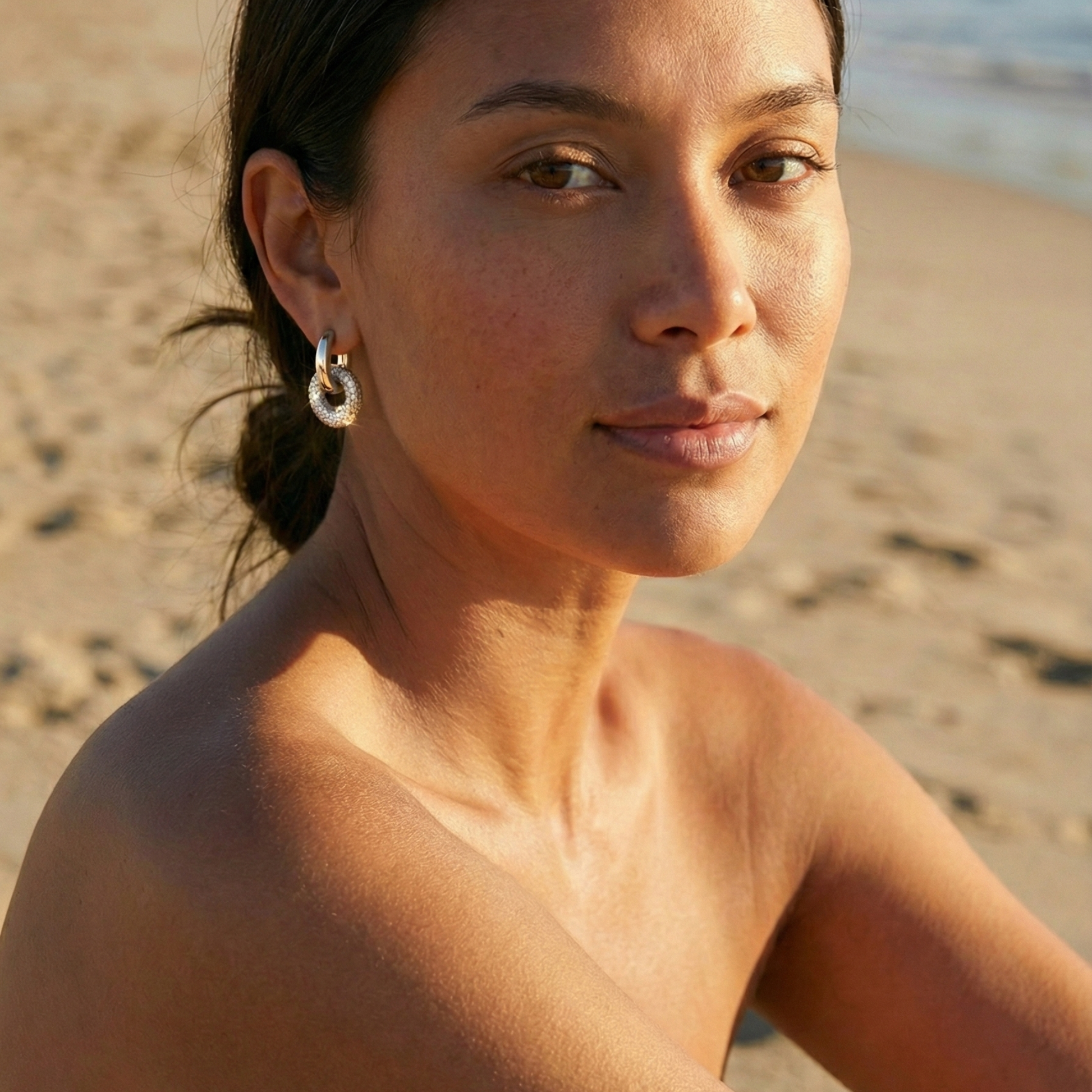 Modern silver hoop earrings with round crystal halo charm