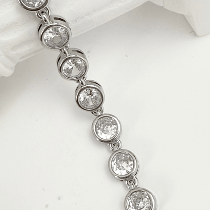 crystal tennis bracelet with bezel-set clear stones.