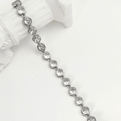 crystal tennis bracelet with bezel-set clear stones.
