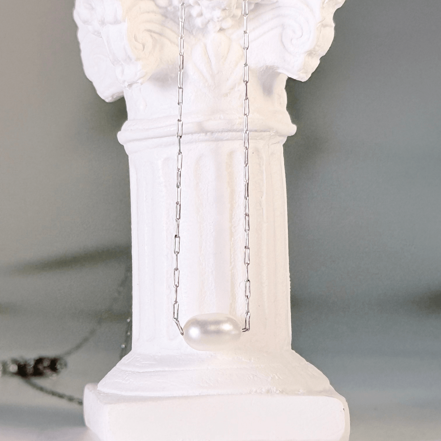 Dainty gold chain necklace with single freshwater pearl, minimalist waterproof design for layering or everyday wear.