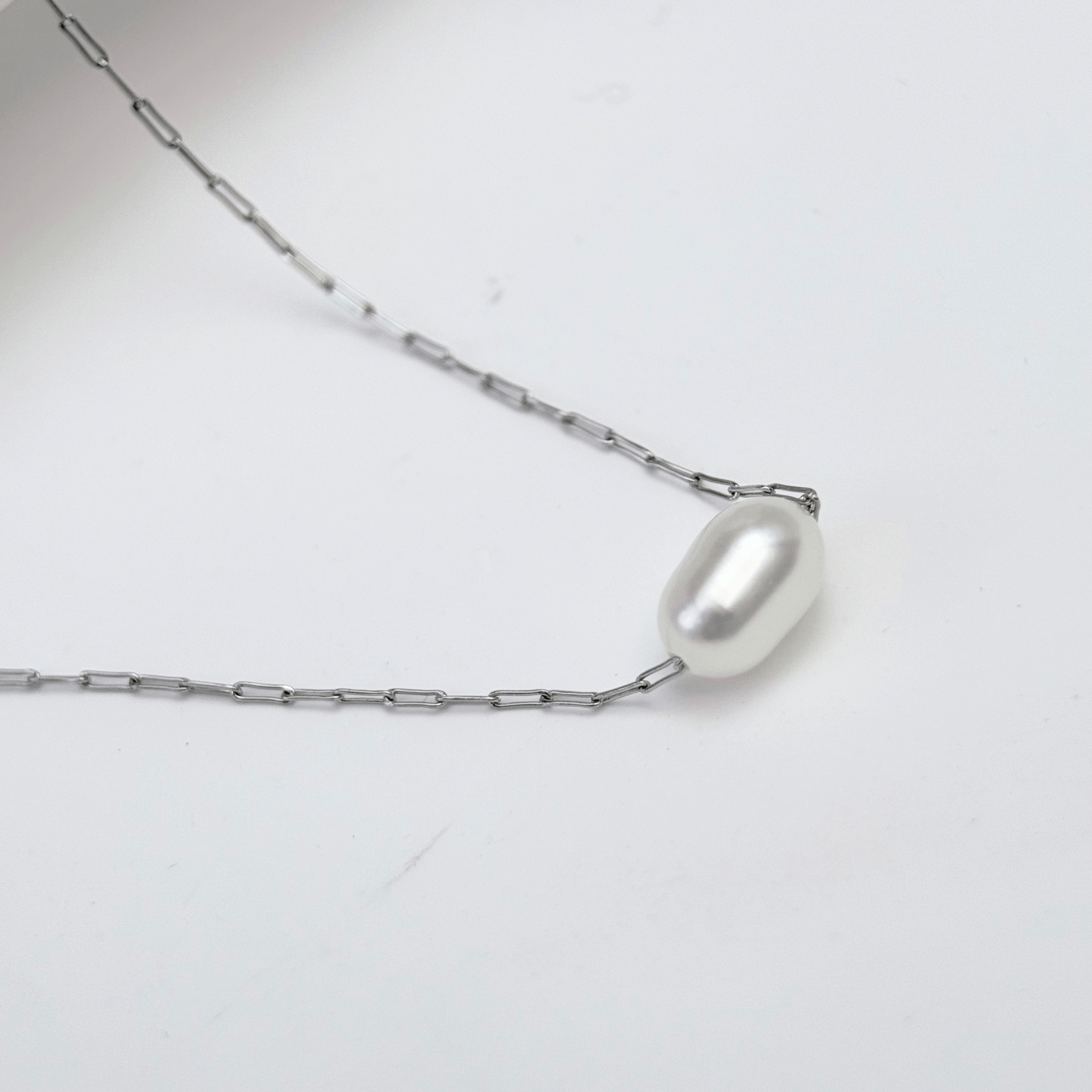 Dainty gold chain necklace with single freshwater pearl, minimalist waterproof design for layering or everyday wear.
