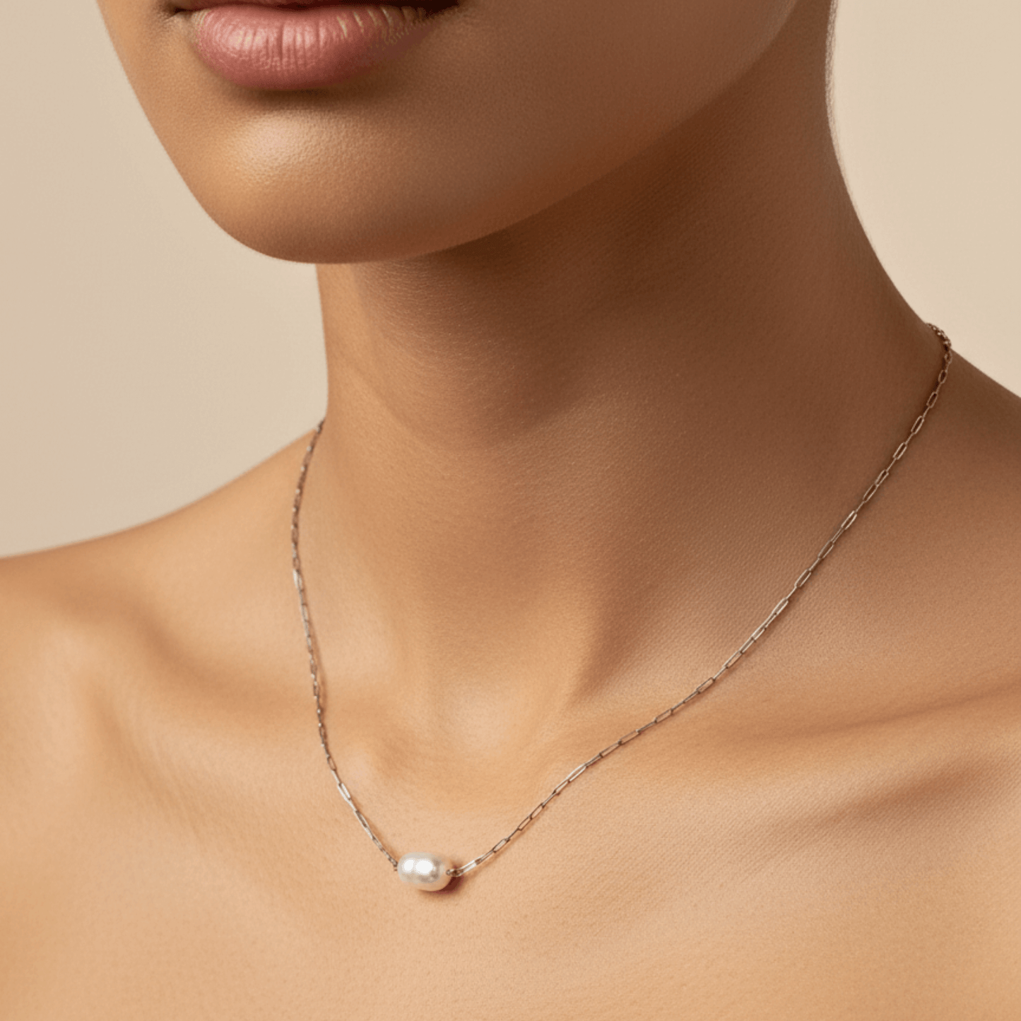 Dainty gold chain necklace with single freshwater pearl, minimalist waterproof design for layering or everyday wear.