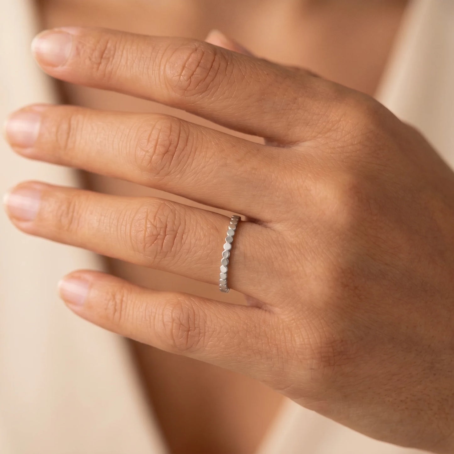 Dainty sterling silver stacking ring with small light-catching disc details