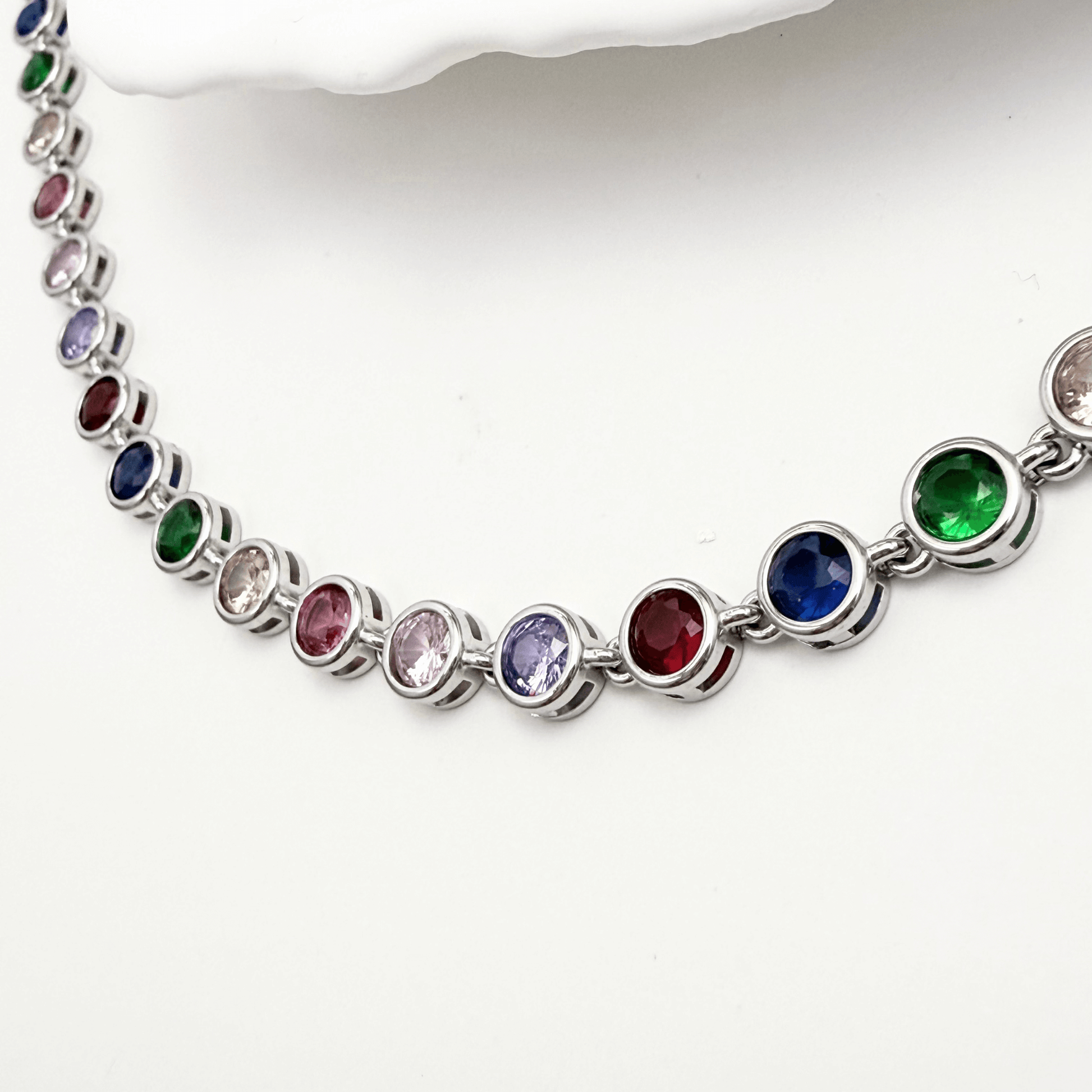 silver rainbow crystal tennis bracelet with multi-coloured bezel-set stones.