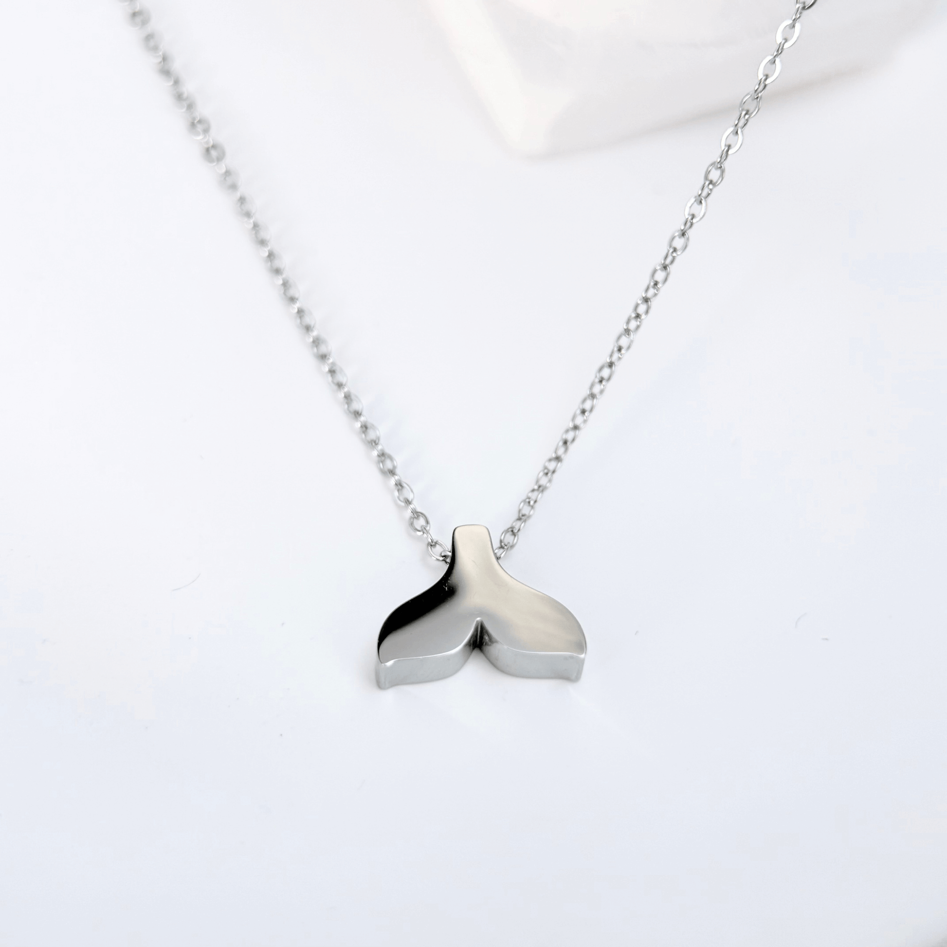 Silver whale tail pendant necklace representing freedom and ocean grace.