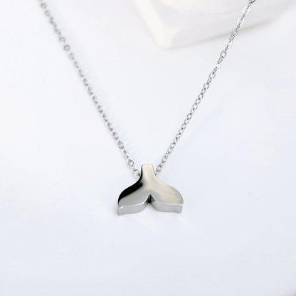 Silver whale tail pendant necklace representing freedom and ocean grace.