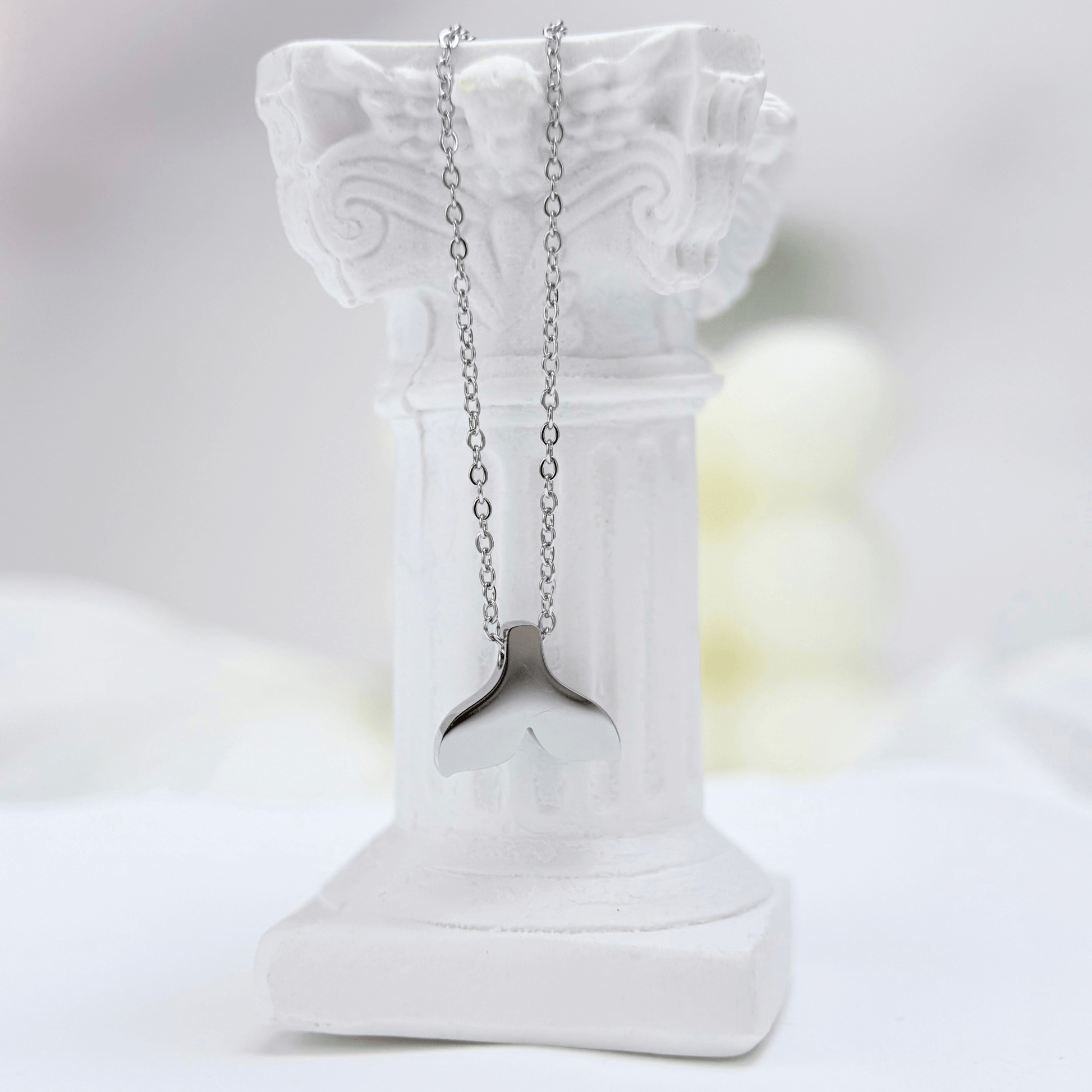 Silver whale tail pendant necklace representing freedom and ocean grace.