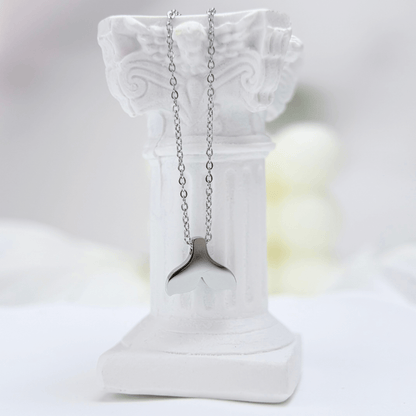 Silver whale tail pendant necklace representing freedom and ocean grace.