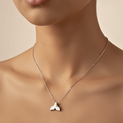 Silver whale tail pendant necklace representing freedom and ocean grace.