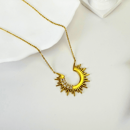 Waterproof sparkling sunburst necklace with a radiant crescent pendant in 18K PVD gold, accented with cubic zirconia