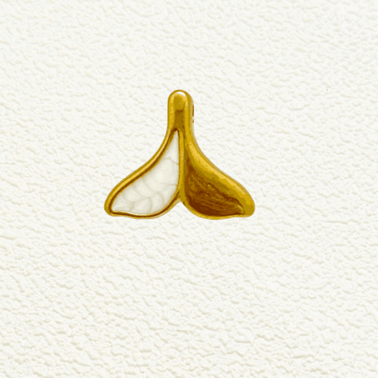 Gold whale tail charm with white enamel split design – ocean-themed pendant