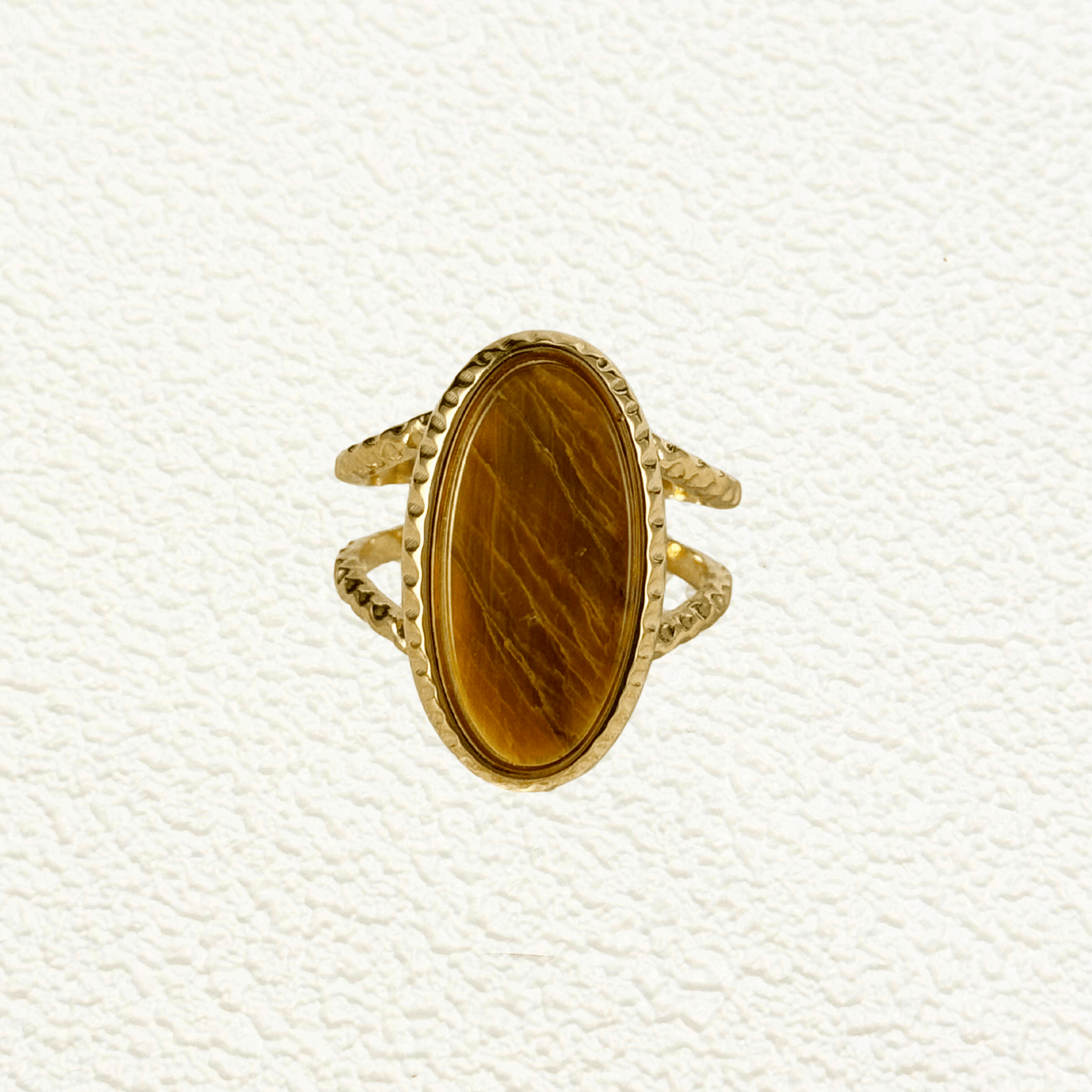 gold statement ring with large oval tiger eye stone and double textured band design.