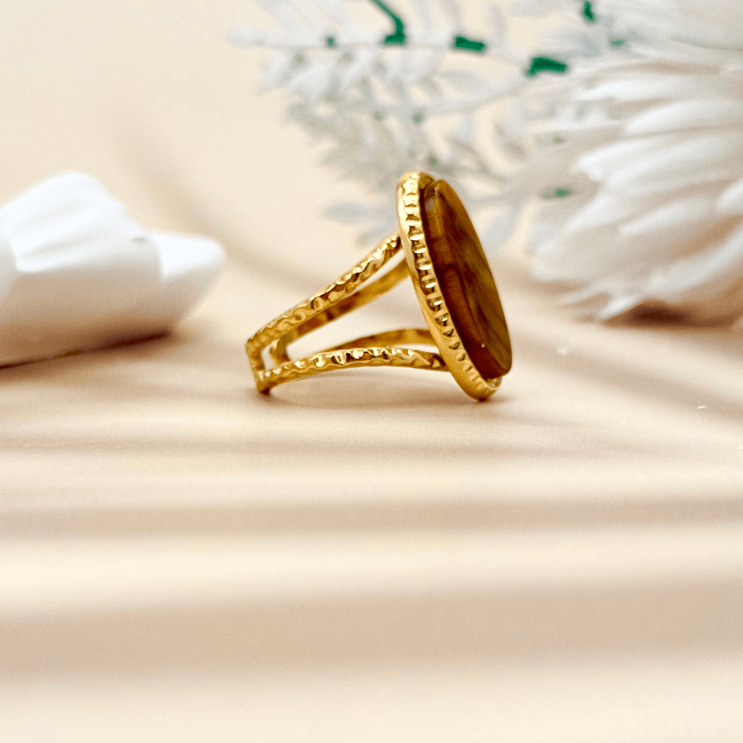 gold statement ring with large oval tiger eye stone and double textured band design.