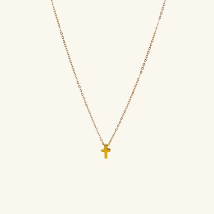 Minimalist gold tiny cross necklace on a fine chain, waterproof and tarnish-resistant, worn close to the neck