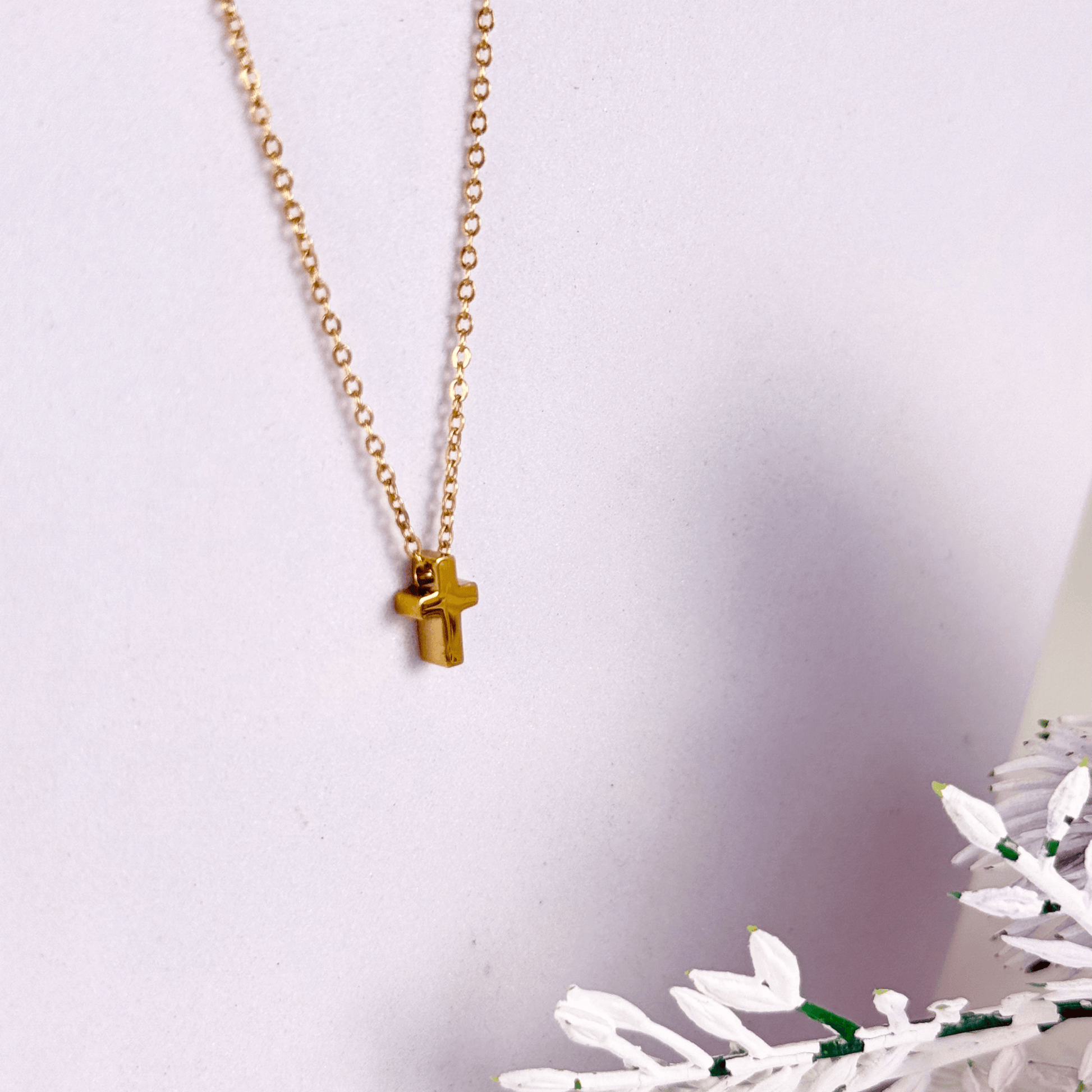 Minimalist gold tiny cross necklace on a fine chain, waterproof and tarnish-resistant
