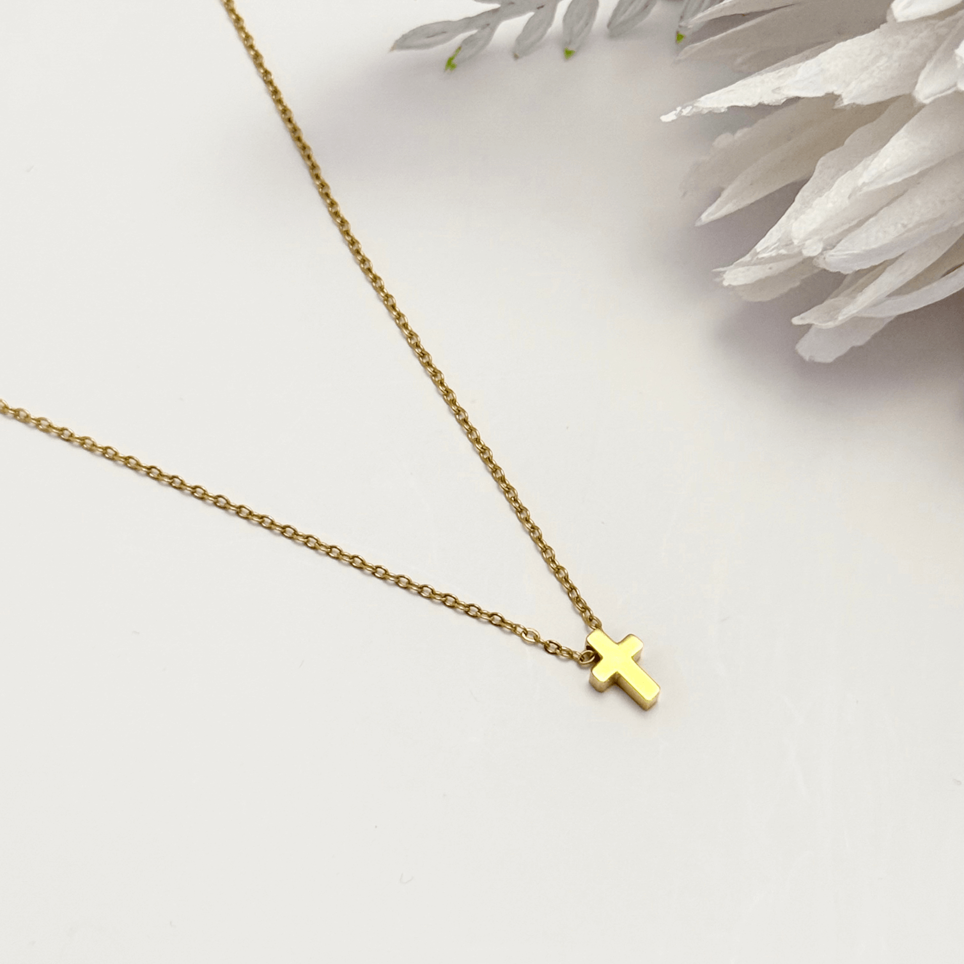 Minimalist gold tiny cross necklace on a fine chain, waterproof and tarnish-resistant