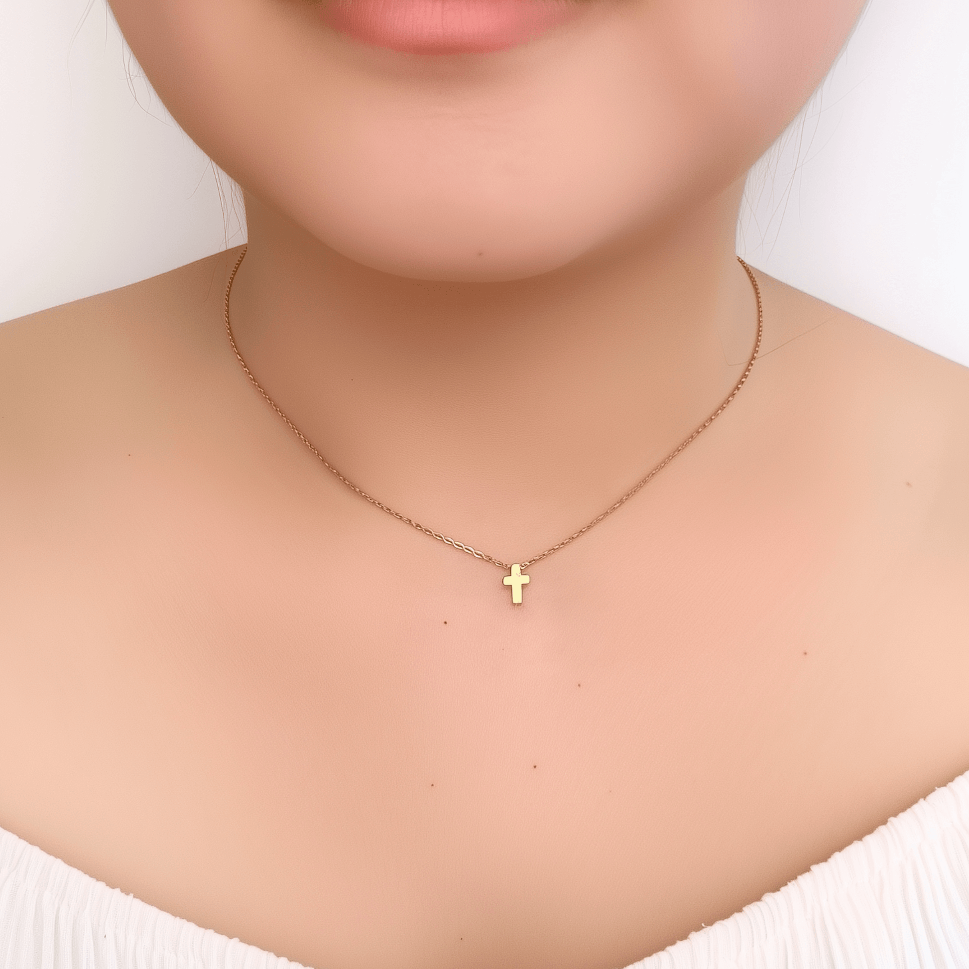 Minimalist gold tiny cross necklace on a fine chain, waterproof and tarnish-resistant