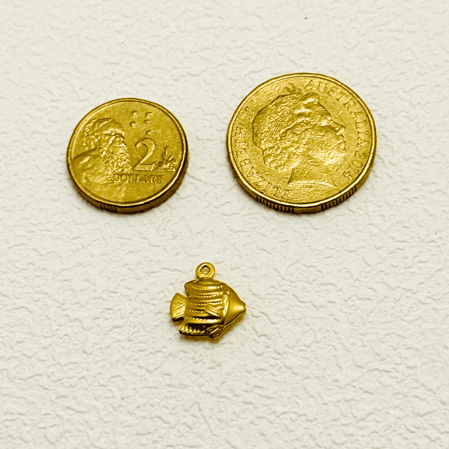 Gold tropical fish charm with detailed fins and scales, lightweight hollow design
