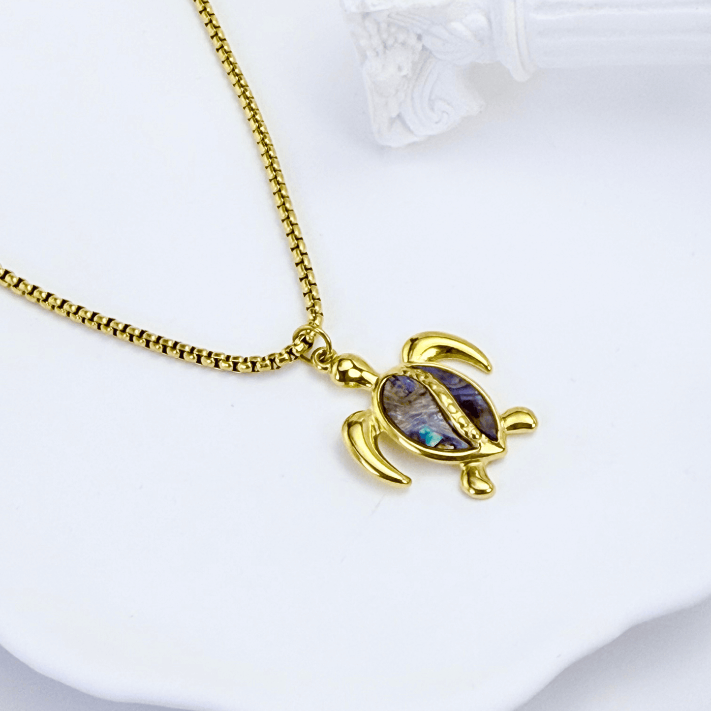 Waterproof gold turtle pendant necklace with abalone shell, shown on model with ocean-inspired details