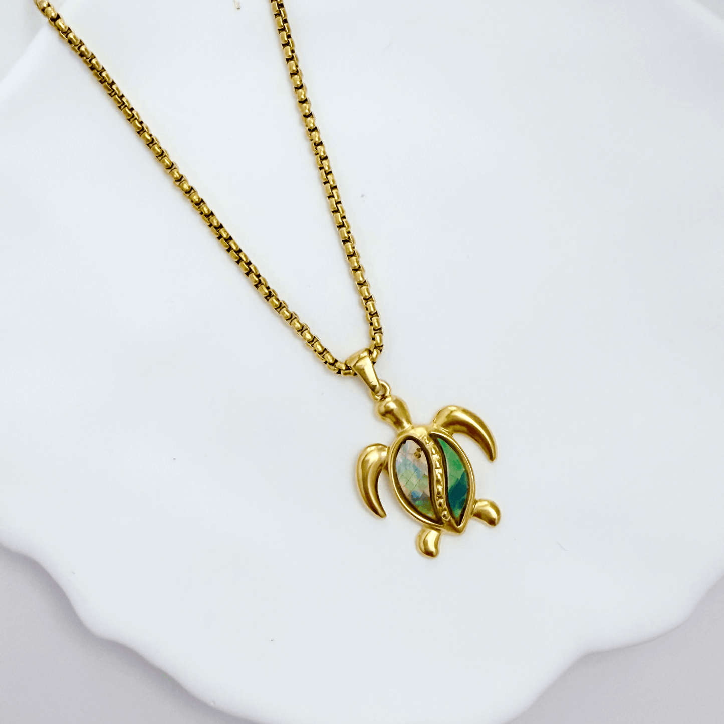 Waterproof gold turtle pendant necklace with abalone shell, shown on model with ocean-inspired details