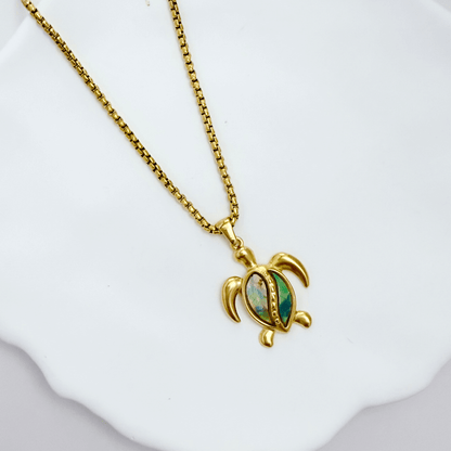 Waterproof gold turtle pendant necklace with abalone shell, shown on model with ocean-inspired details