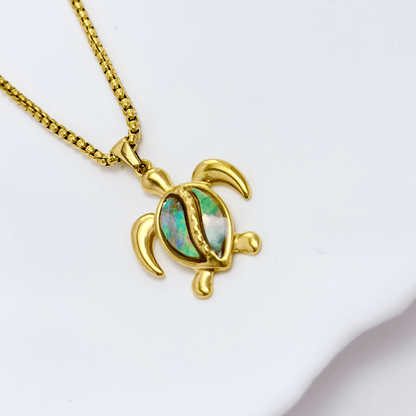 Waterproof gold turtle pendant necklace with abalone shell, shown on model with ocean-inspired details