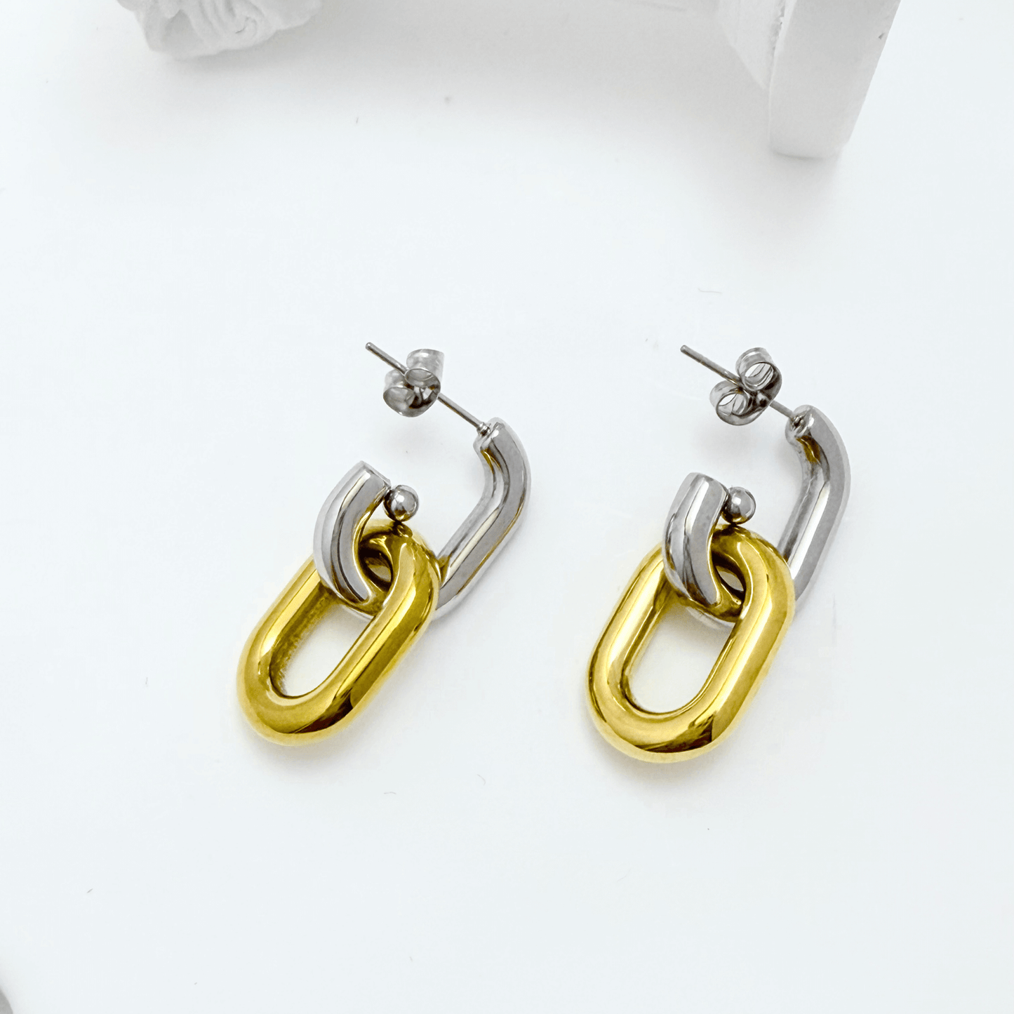 Mixed-metal link drop earrings in gold and silver.