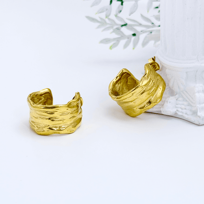 Close-up of molten texture gold hoop earrings