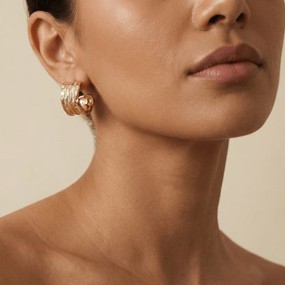 Close-up of molten texture gold hoop earrings