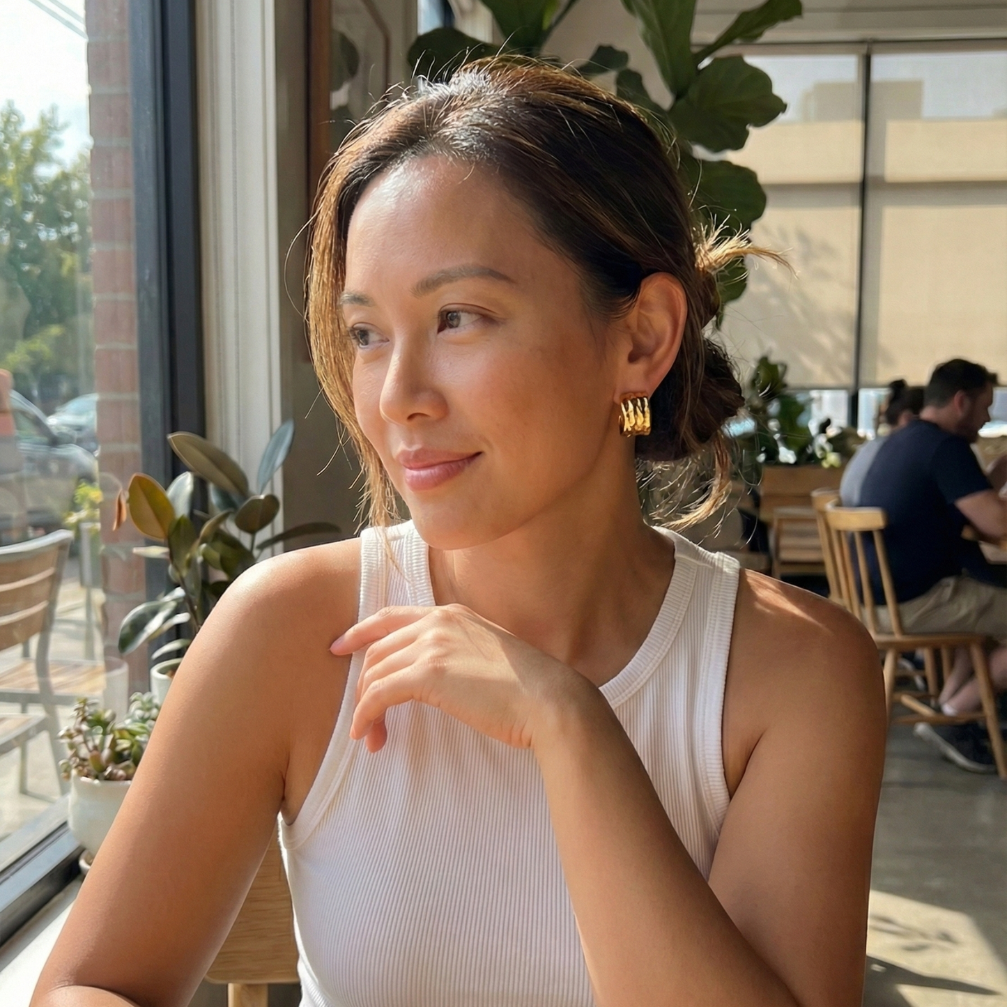 Close-up of molten texture gold hoop earrings