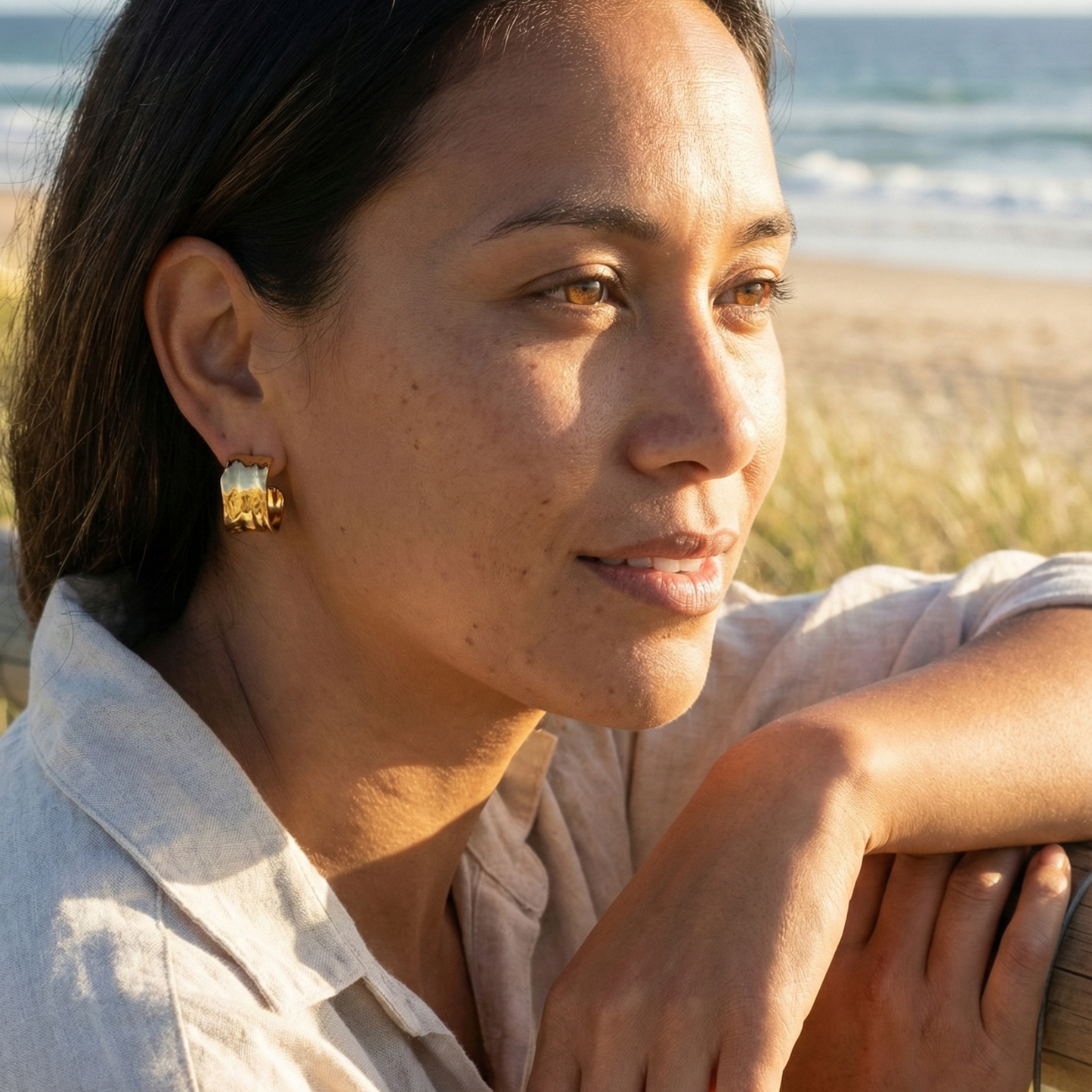 Close-up of molten texture gold hoop earrings