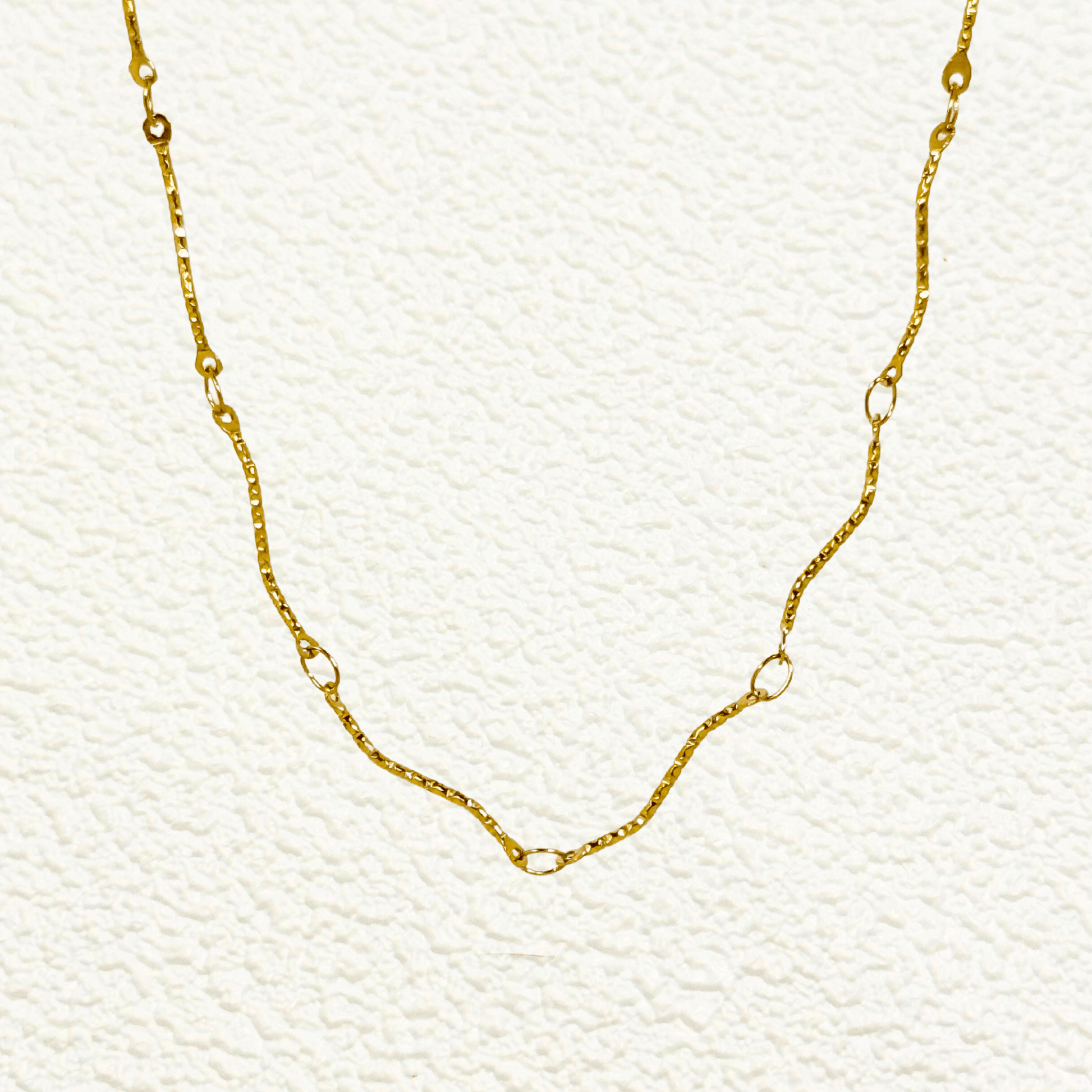 Wave Link Gold Chain made from waterproof gold PVD-plated stainless steel with textured wavy links