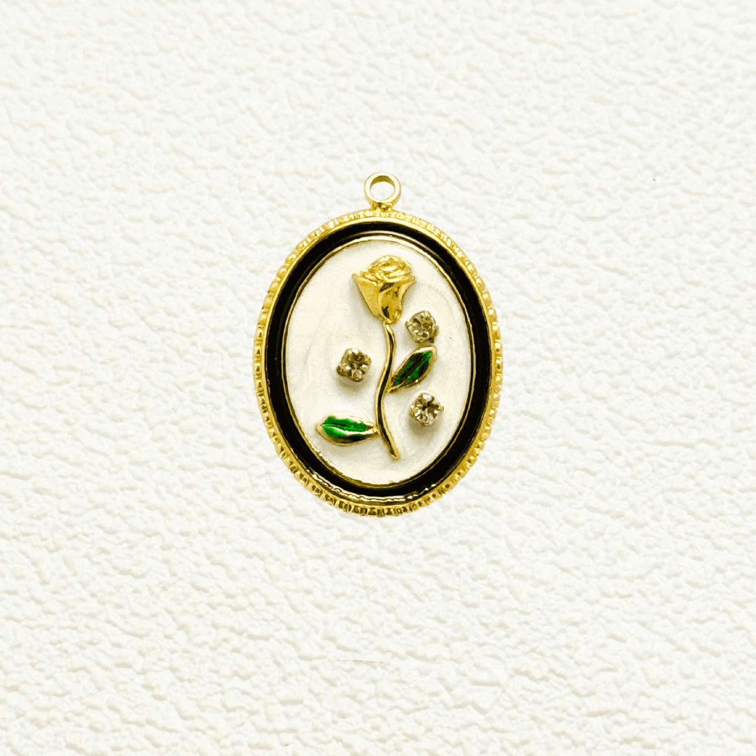 Elegant oval charm with sculpted golden rose, green enamel leaves, and embedded zircon accents on white enamel – floral vintage-style pendant for custom necklaces.