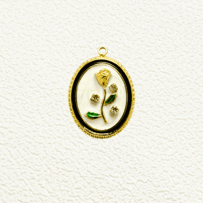 Elegant oval charm with sculpted golden rose, green enamel leaves, and embedded zircon accents on white enamel – floral vintage-style pendant for custom necklaces.