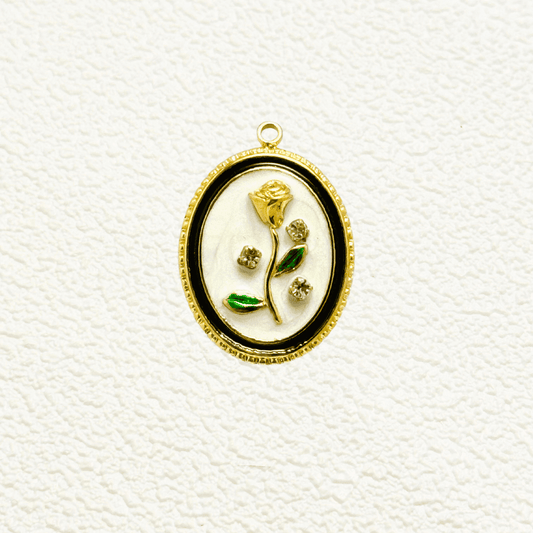Elegant oval charm with sculpted golden rose, green enamel leaves, and embedded zircon accents on white enamel – floral vintage-style pendant for custom necklaces.