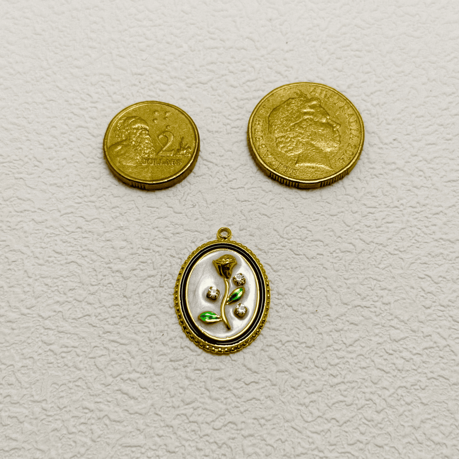 Elegant oval charm with sculpted golden rose, green enamel leaves, and embedded zircon accents on white enamel – floral vintage-style pendant for custom necklaces.